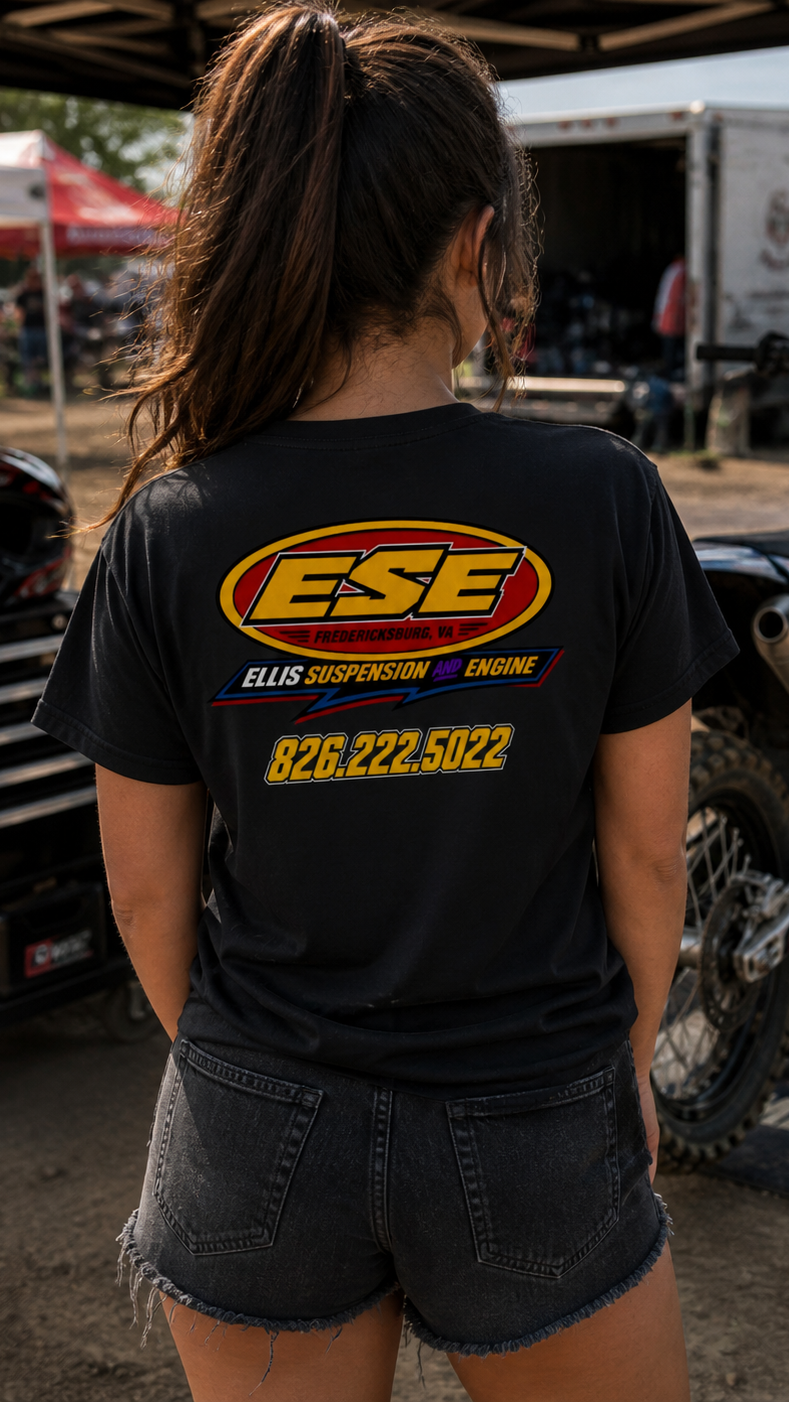 Person wearing a black t-shirt with 'ESE' logo and contact information at a dirt bike event.